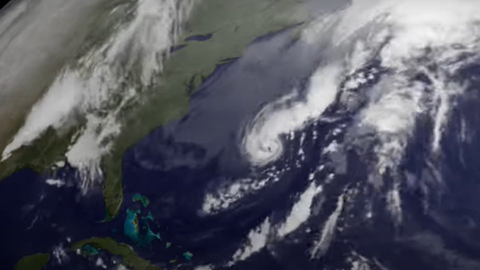 A satellite view of the eastern United States and the western Atlantic, with a tightly wound storm spinning off the Northeast coast
