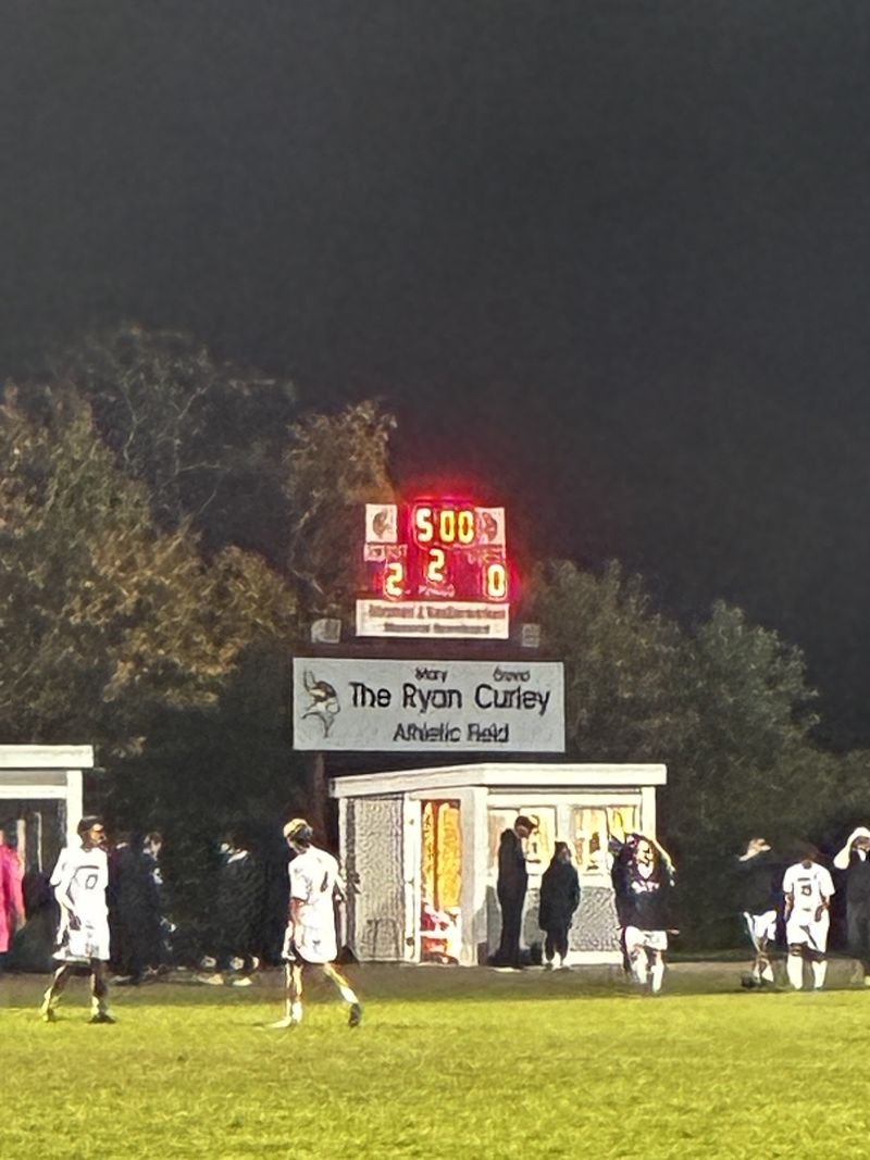 The Rockport High scoreboard shows 2 to 0 in the second half above the Ryan Curley Athletic Field sign, with players on the field below