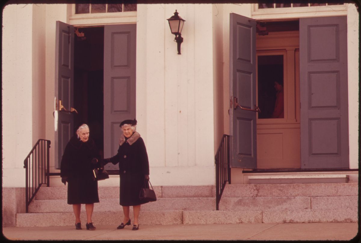 Two women talk on the front steps of the Rockport Congregational Church on a Sunday morning in 1973