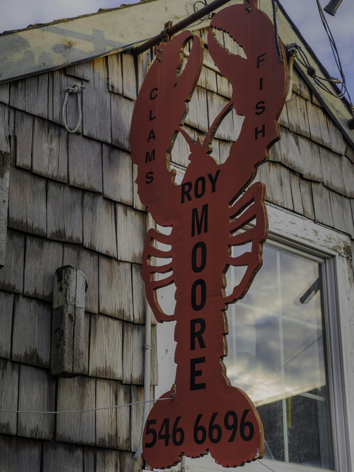 Lobster sign on a shingled wall in Rockport